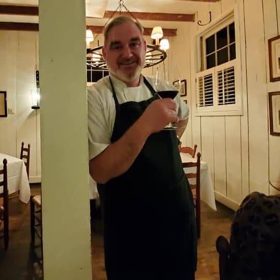 Chef John Loeffler holding a wine glass