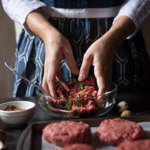 Chef working with ground beef from Chapel Hill Farms