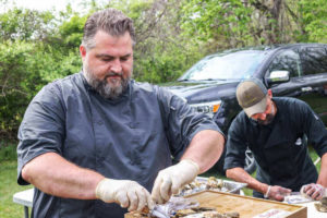 Chef Erik shucking oysters at Hillbrook Inn's 2022 Root to Table event