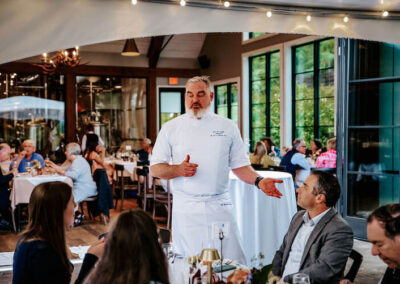 Chef John talking to guests at Root to Table's Bavarian Inn 2023 event